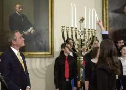 U.S. President George W. Bush watches as Alexandra Wald, 15, of New York City